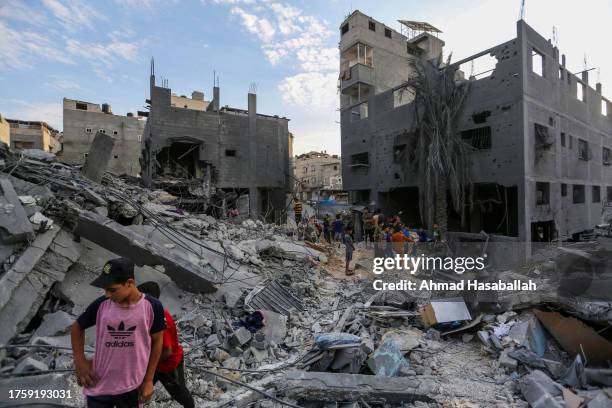 People search through buildings that were destroyed during Israeli air raids in the southern Gaza Strip on October 27, 2023 in Khan Yunis, Gaza. Two...