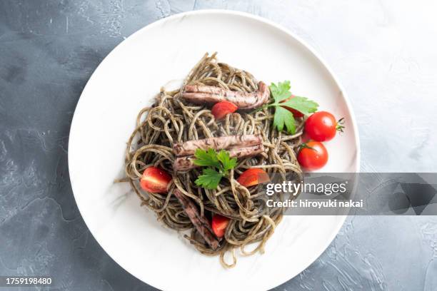 pasta with squid ink sauce - squid ink pasta stock pictures, royalty-free photos & images