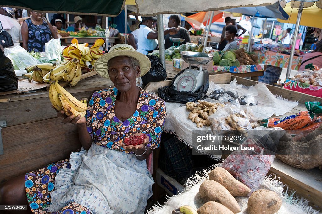 Woman sells bananas and fruits at market