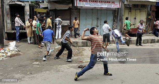 Protestors throwing stones on Police during a clash between protestors and Indian police officials on August 10, 2013 in Jammu, India. A town in the...