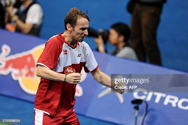 Denmark's Mathias Boe celebrates after winning his men's doubles semi-final with his team member Carsten Mogensen against South Korea's Kim Ki Jung...