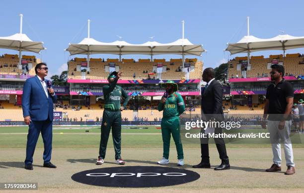 Babar Azam of Pakistan flips the coin as Temba Bavuma of South Africa looks on ahead of the ICC Men's Cricket World Cup India 2023 between Pakistan...