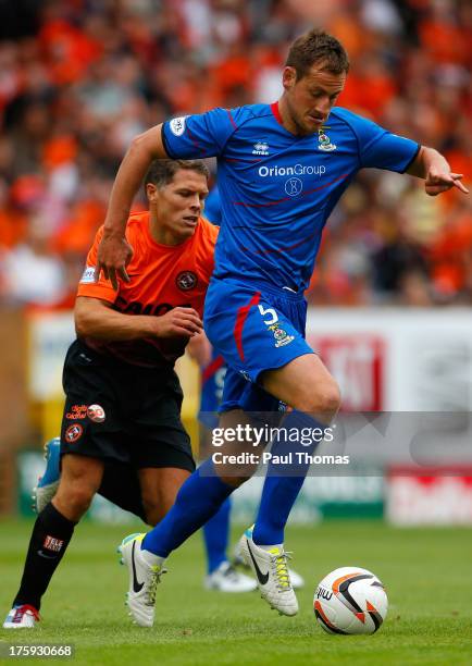 John Rankin of Dundee United in action with Gary Warren of Inverness Caledonian Thistle during the Scottish Premier League match between Dundee...