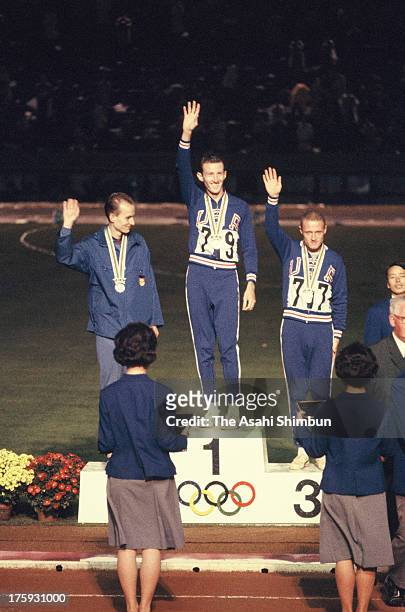 Gold medalist Bob Schul of United States, Silver medalist Harald Norpoth of Germany and Bronze medalist Bill Dellinger of the United States pose on...