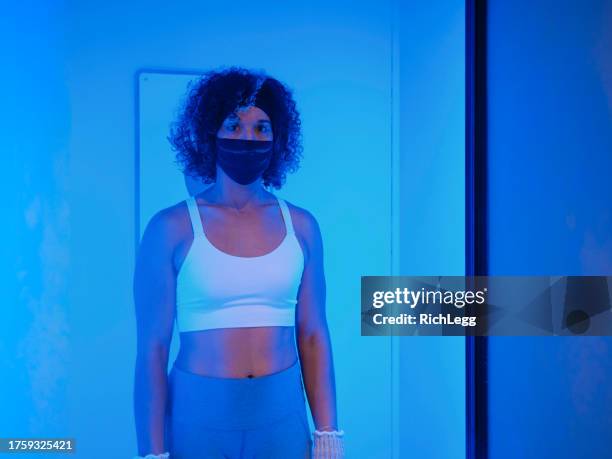 young woman in a cryotherapy chamber - cryotherapy stockfoto's en -beelden