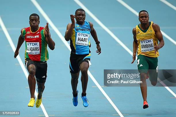 Antoine Adams of Saint Kitts and Nevis, Shavez Hart of Bahamas and Akani Simbine of South Africa compete in the Men's 100 metres heats during Day One...