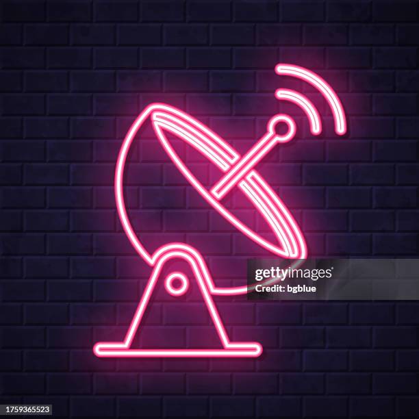 satellite dish. glowing neon icon on brick wall background - observatory stock illustrations