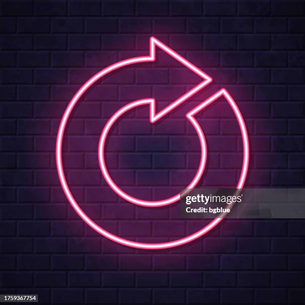 refresh. glowing neon icon on brick wall background - intersection night stock illustrations