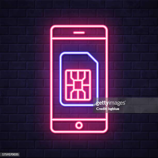 smartphone with sim card. glowing neon icon on brick wall background - touch screen wall stock illustrations