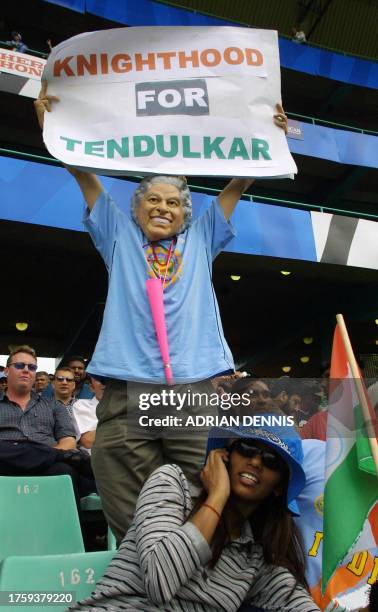 An Indian fan posing as Queen Elizabeth advertises his opinion about Indian batsman Sachin Tendulkar during the semi-final match between India and...