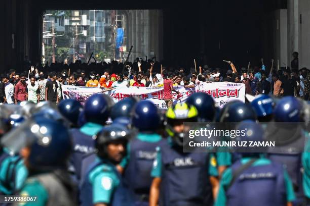 Bangladesh police stand guard as garment workers protest to demand the increase of their salaries, in Dhaka on November 2, 2023. Hundreds of garment...