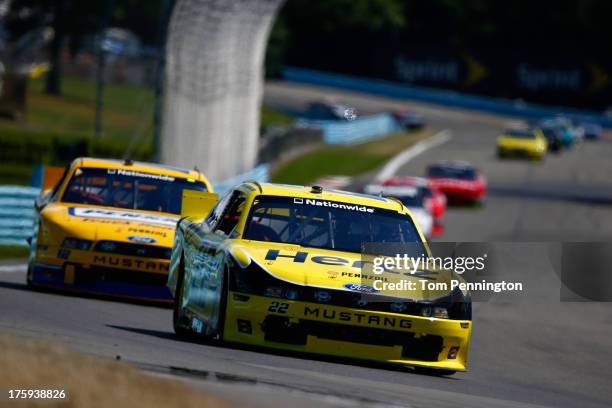 Brad Keselowski, driver of the Hertz Ford, leads Sam Hornish Jr., driver of the Penske Truck Rental Ford, during the NASCAR Nationwide Series Zippo...