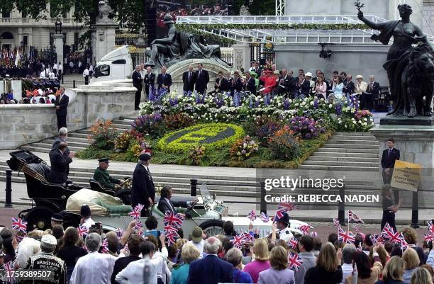 The Victoria Cross and George Cross Association pass members of the Royal family watching a parade in The Mall in London, 04 June 2002, as part of...