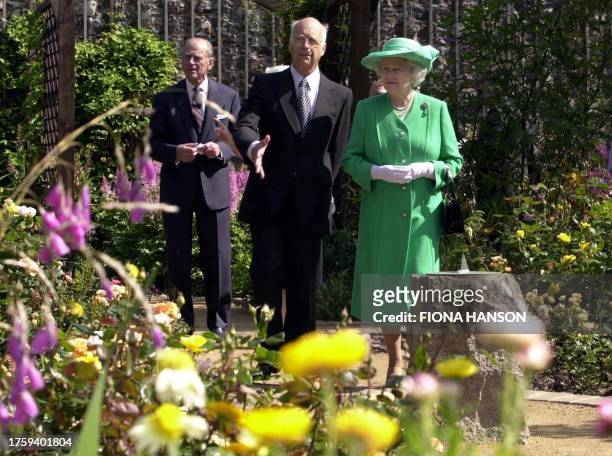 Britain's Queen Elizabeth II is accompanied around the Seigneurie gardens by the Seigneur, Michael Beaumont , on the island of Sark 12 July 2001 at...