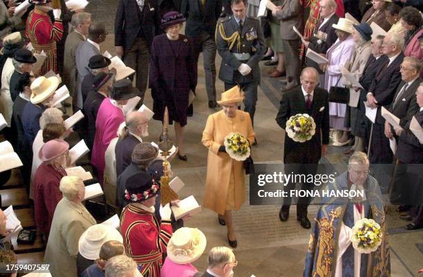 Britain's Queen Elizabeth II and The Duke of Edinburgh arrive at Westminster Abbey in London 12 April 2001 for the traditional Maundy Service. The...