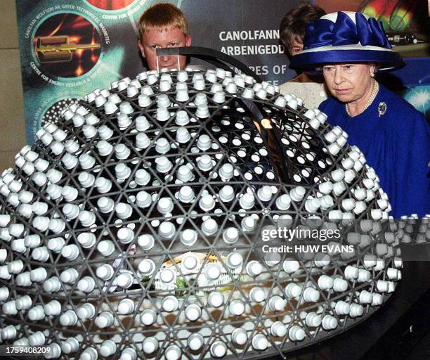 Britain's Queen Elizabeth II studies a model of SkyDome produced by the Welsh School of Architecture while on a visit to Cardiff University to see...