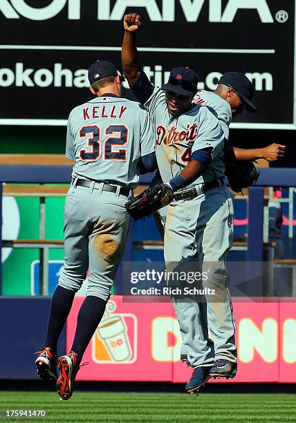 Outfielders Don Kelly, Torii Hunter and Austin Jackson of the Detroit Tigers congratulate each other after they defeated the New York Yankees 9-3 in...