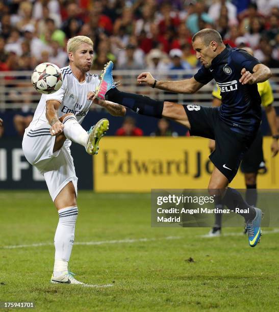 Sergio Ramos of Real Madrid competes for the ball with Rodrigo Palacio of Inter Milan during the pre-season friendly match between Real Madrid CF and...