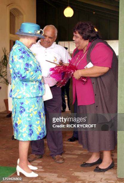 Britain's Queen is presented with traditional aboriginal hunting tools of a boomerang and a nulla nulla by Greg McKellar and his wife Francis at the...