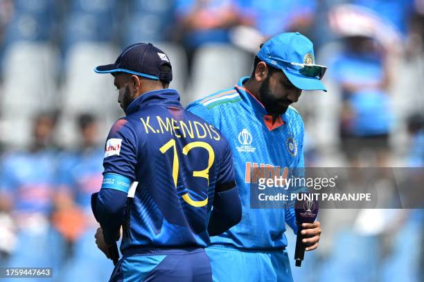 India's captain Rohit Sharma and his Sri Lankan counterpart Kusal Mendis walk during the toss before the start of the 2023 ICC Men's Cricket World...