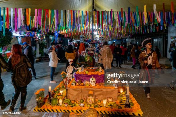 November 2023, Mexico, Mexiko-Stadt: People commemorate the deceased with colorfully decorated home altars and orange flowers on November 1 and 2....