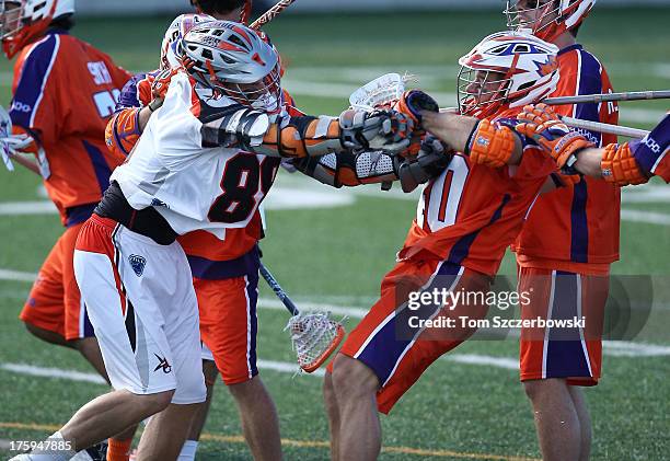 Zack Greer of the Denver Outlaws battles with Matt Lovejoy of the Hamilton Nationals during Major League Lacrosse game action on August 10, 2013 at...