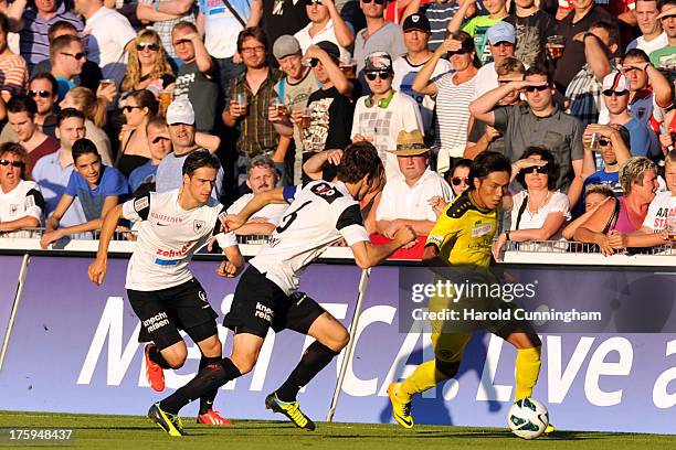 Yuya Kubo of BSC Young Boys vies with Sandro Burki of FC Aarau during the Swiss Super League match between FC Aarau v BSC Young Boys at Brugglifeld...