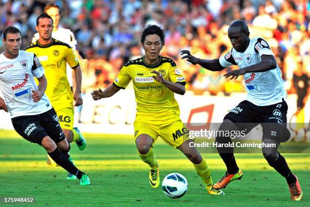 Yuya Kubo of BSC Young Boys vies with Igor Nganga of FC Aarau during the Swiss Super League match between FC Aarau v BSC Young Boys at Brugglifeld on...