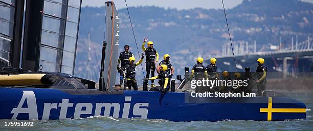 Members of Team Artemis Racing wave to the crowd after losing to Team Luna Rossa Challenge during race four of the Louis Vuitton Cup semi final on...