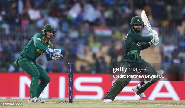 Shadab Khan of Pakistan plays a shot as Quinton de Kock of South Africa keeps during the ICC Men's Cricket World Cup India 2023 between Pakistan and...