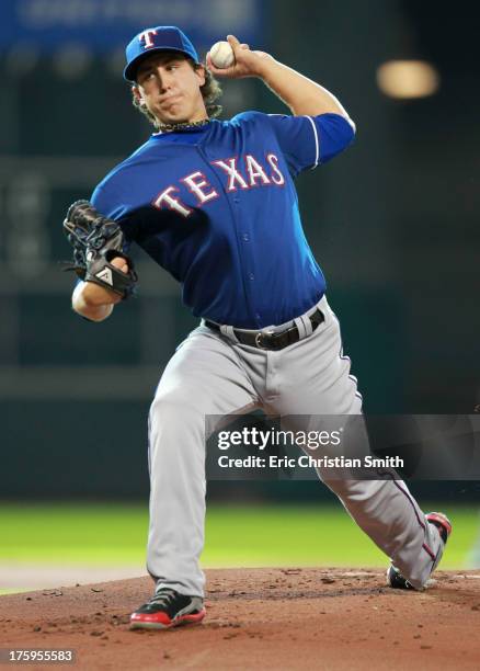 Derek Holland of the Texas Rangers delivers a pitch during the first inning against the Houston Astros on August 10, 2013 at Minute Maid Park in...