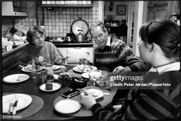 Farmer David Wells takes a break from work to have lunch with his wife Pat and new helper Claire Giles on the now isolated Totteridge Farm in the...