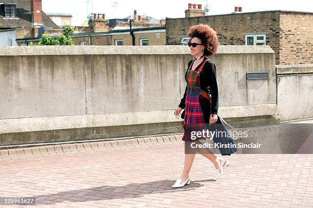 Fashion graduate Sadie Clayton wears a Natalie Rowland dress, Zara shoes, vintage earrings and an e-bay bag on day 4 of Graduate Fashion week on June...