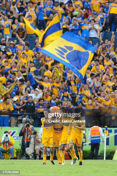 Alan Pulido of Tigres celebrates with teammates after scoring during a match between Tigres and Monterrey as part of Apertura 2013 Tournament, at...
