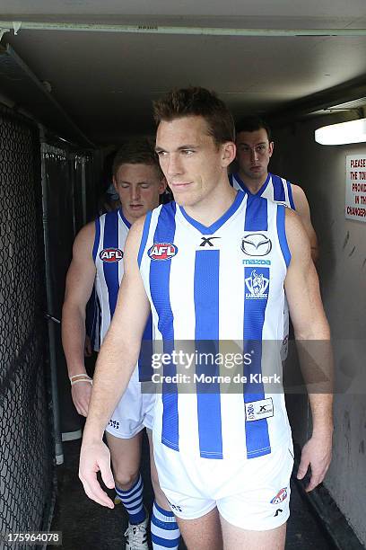 Drew Petrie of the Kangaroos leads the team onto the field before the round 20 AFL match between the Adelaide Crows and the North Melbourne Kangaroos...