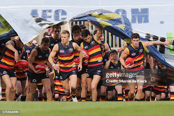 Nathan van Berlo of The Crows leads his team onto the field before the round 20 AFL match between the Adelaide Crows and the North Melbourne...