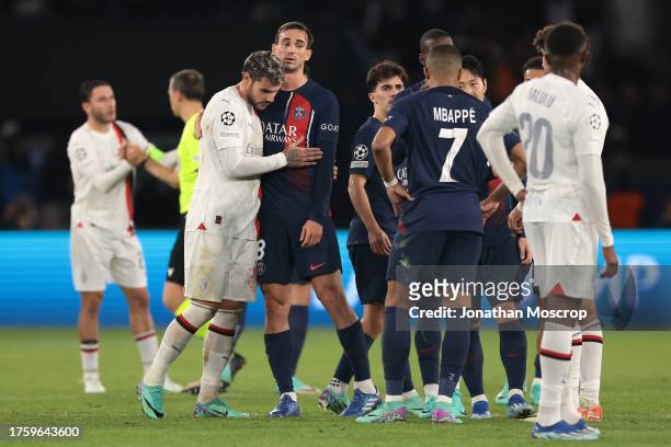 Theo Hernandez of AC Milan emrbaces Fabian Ruiz of PSG as players from both teams salute each other following the final whistle of the UEFA Champions...