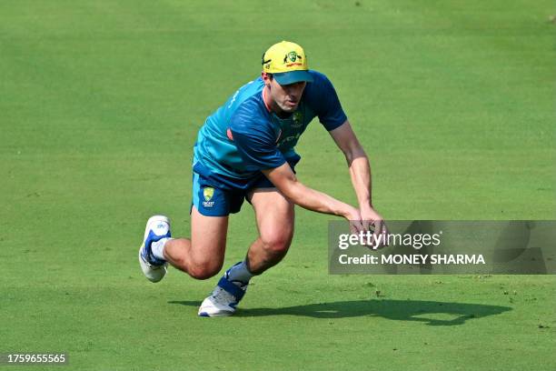 Australia's captain Pat Cummins catches the ball during a practice session ahead of their 2023 ICC Men's Cricket World Cup one-day international...