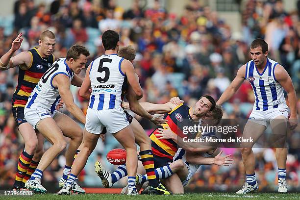 Brad Crouch of The Crows is surrounded by defenders during the round 20 AFL match between the Adelaide Crows and the North Melbourne Kangaroos at...