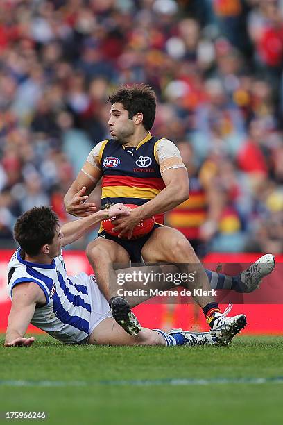 Jared Patrenko of The Crows is tackled during the round 20 AFL match between the Adelaide Crows and the North Melbourne Kangaroos at AAMI Stadium on...