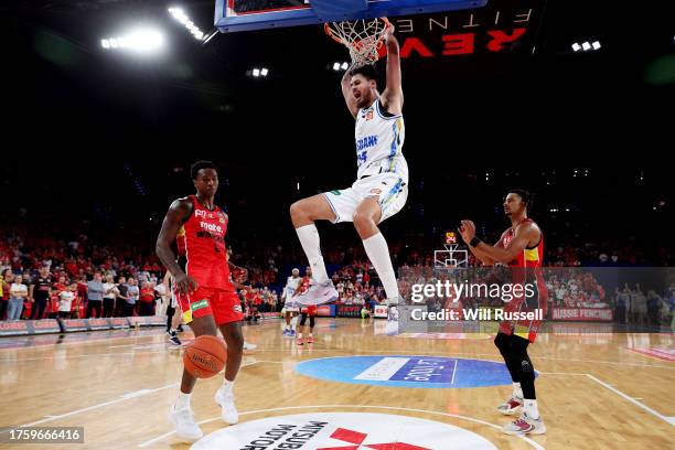 Tyrell Harrison of the Brisbane Bullets hangs from the basket during the round five NBL match between Perth Wildcats and Brisbane Bullets at RAC...