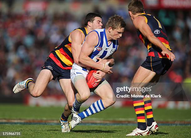 Brad Crouch of The Crows tackles Jack Ziebell of The Kangaroos during the round 20 AFL match between the Adelaide Crows and the North Melbourne...