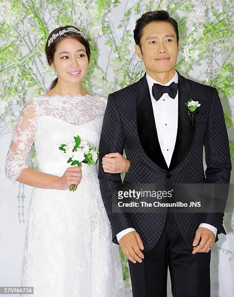 Lee Min-Jung and Lee Byung-Hun pose for photographs before their wedding at Grand Hyatt Hotel on August 10, 2013 in Seoul, South Korea.