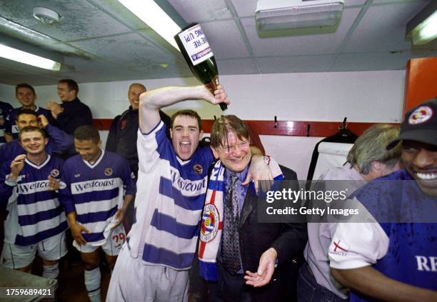 Reading Chairman John Madejski is covered in champagne in the dressing room by Andrew Hughes after Reading had secured promotion to League One after...