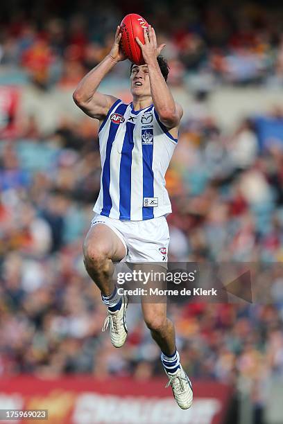 Scott Thompson of The Kangaroos takes a mark during the round 20 AFL match between the Adelaide Crows and the North Melbourne Kangaroos at AAMI...