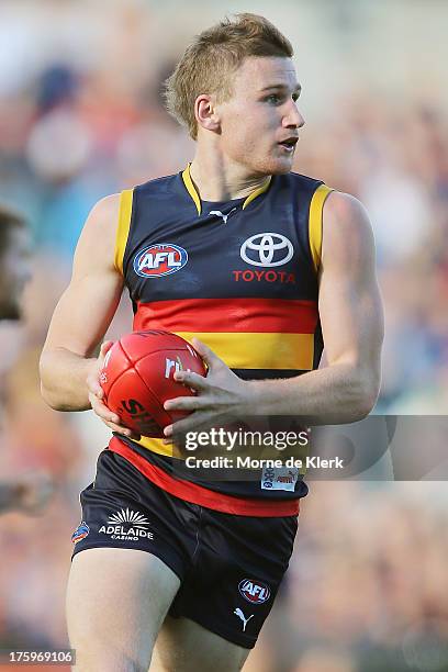 Rory Laird of The Crows runs with the ball during the round 20 AFL match between the Adelaide Crows and the North Melbourne Kangaroos at AAMI Stadium...