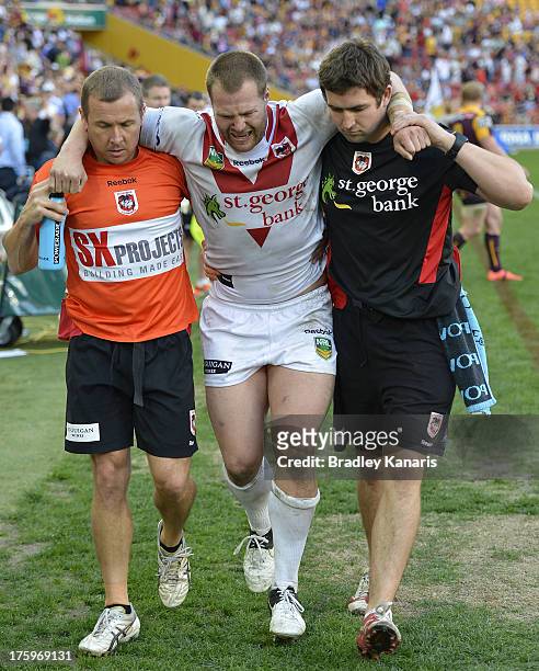Trent Merrin of the Dragons is taken from the field injured during the round 22 NRL match between the Brisbane Broncos and the St George Illawarra...
