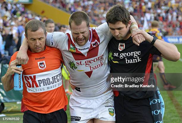 Trent Merrin of the Dragons is taken from the field injured during the round 22 NRL match between the Brisbane Broncos and the St George Illawarra...