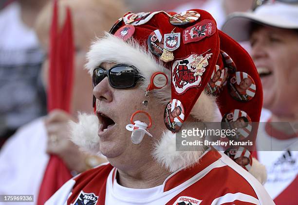 Dragons fan shows his colours during the round 22 NRL match between the Brisbane Broncos and the St George Illawarra Dragons at Suncorp Stadium on...