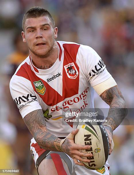 Josh Dugan of the Dragons looks to pass during the round 22 NRL match between the Brisbane Broncos and the St George Illawarra Dragons at Suncorp...